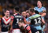 Nicho Hynes (right) celebrates one of six Cronulla tries in the high-scoring win over the Roosters. (Dave Hunt/AAP PHOTOS)