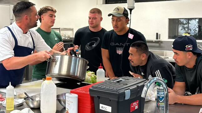 Raiders players learning to cook. Picture Raiders Media