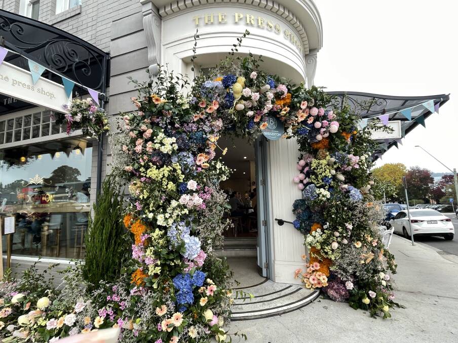 Flowers adorn the entrance to The Press Shop Cafe in Bowral for the Bridgerton event. Picture by Briannah Devlin