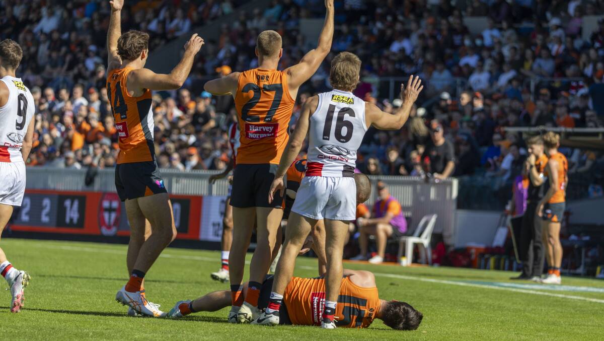 Giants and St Kilda players call for medical staff after Sam Taylor was injured. Picture by Gary Ramage
