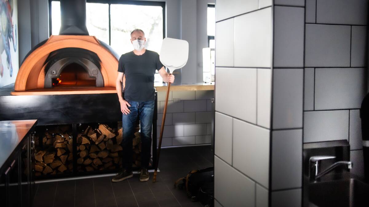 Smoko co-owner Colin Lagos with the wood-fired pizza oven in his new pizzeria in Fyshwick. Picture: Karleen Minney