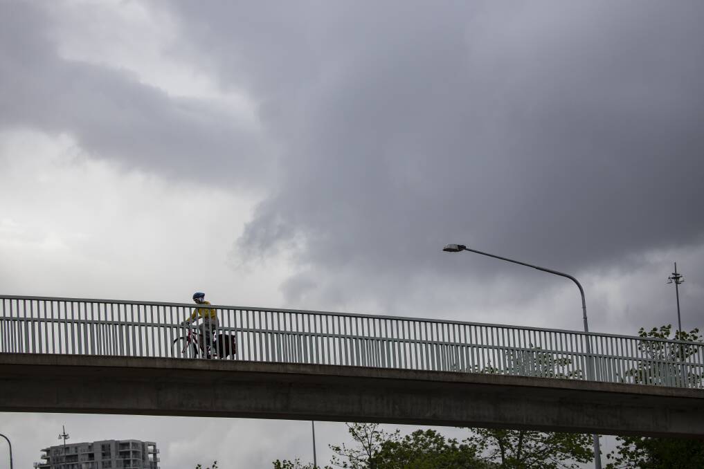 A cyclist rides over a bridge in Canberra last summer. Picture: Sitthixay Ditthavong