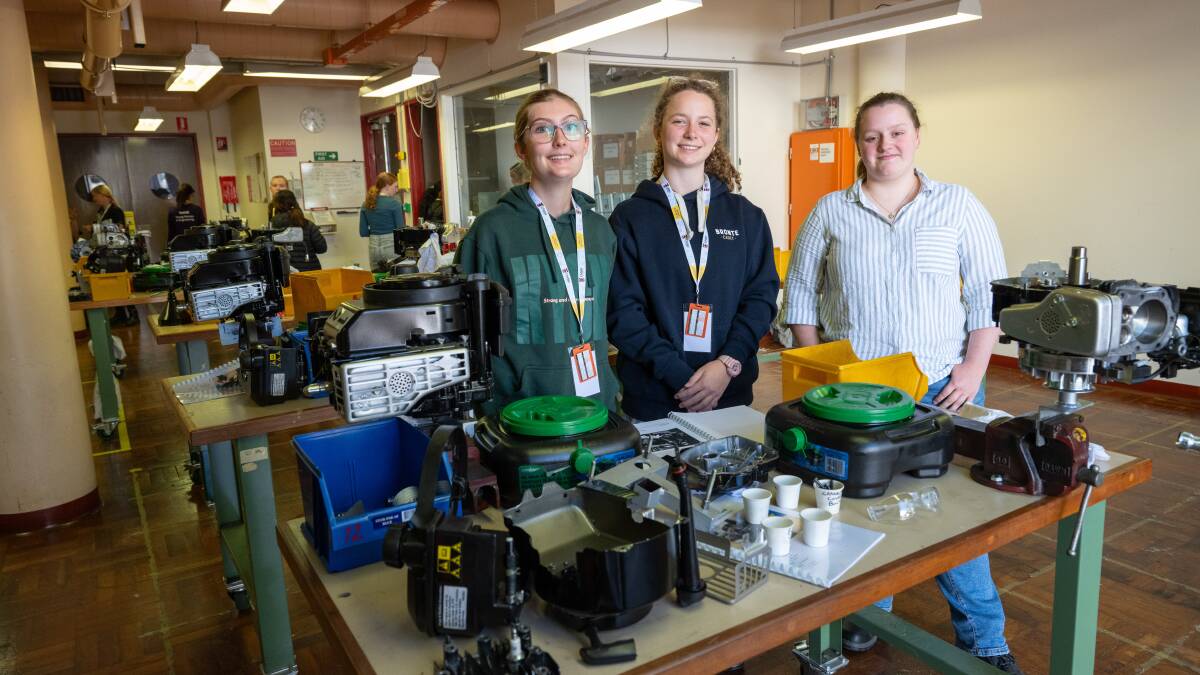 High school students from Sydney, Laura Janes and Claudia Gerber, with electrical engineering student Cat Macdermott. Picture by Elesa Kurtz