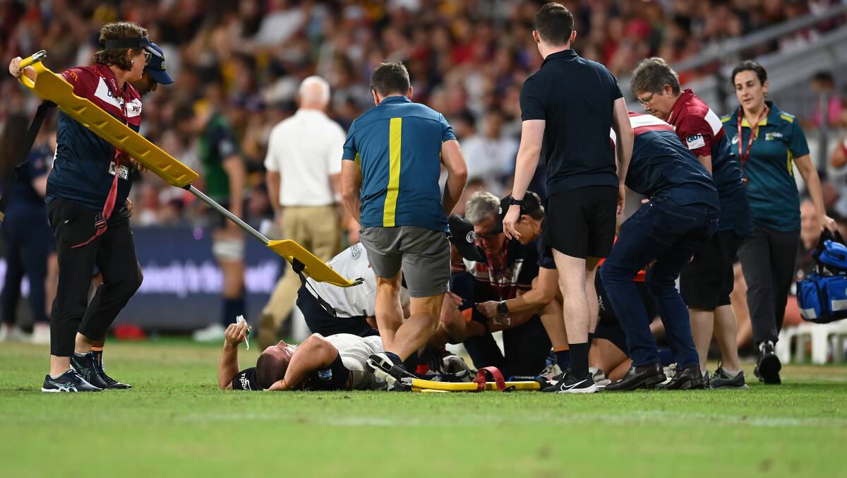 ACT Brumbies hooker Lachlan Lonergan lies on the field in pain after an awkward tackle. Picture Getty Images