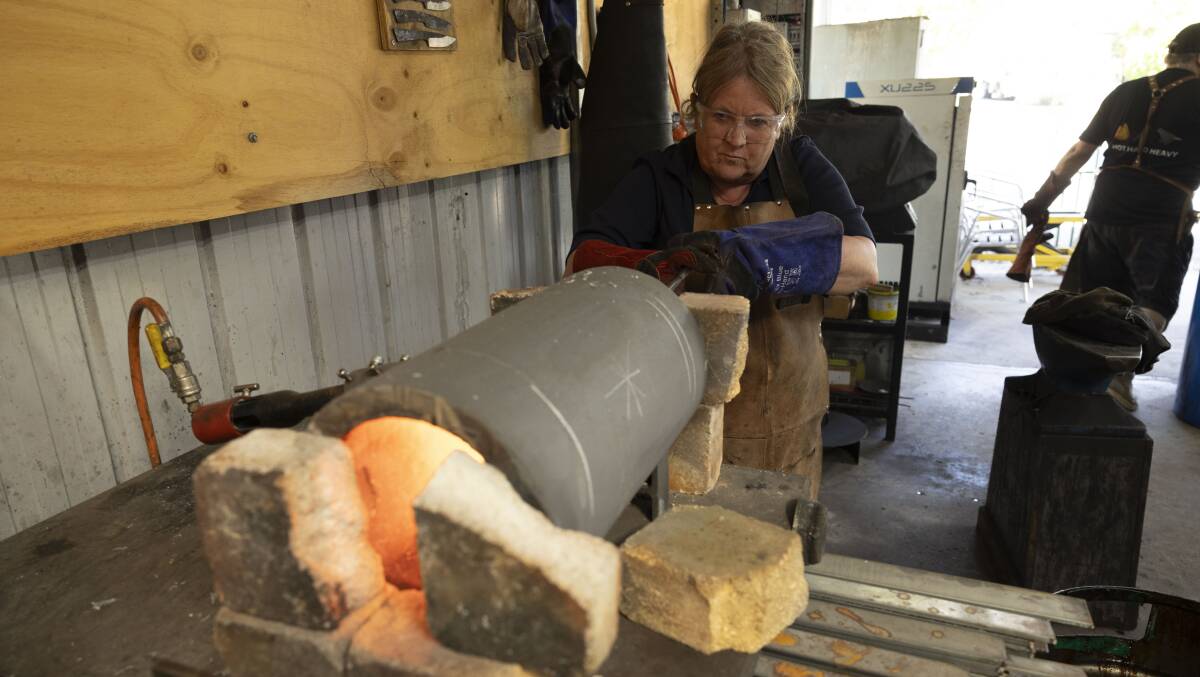 Karen Hardy uses the forge to make her knife. Picture by Gary Ramage