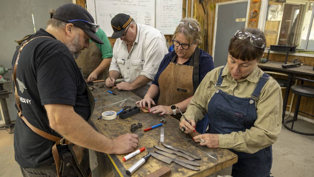 Instructor Tim Baker leads the class as they make their knife handles. Picture by Gary Ramage