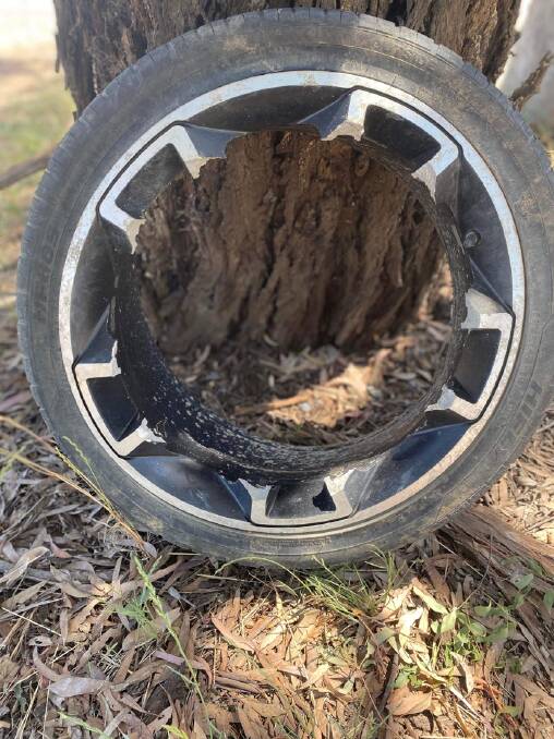 An alloy wheel wheel was shattered by a pothole on Mulligans Flat Road. Picture by Peter Brewer