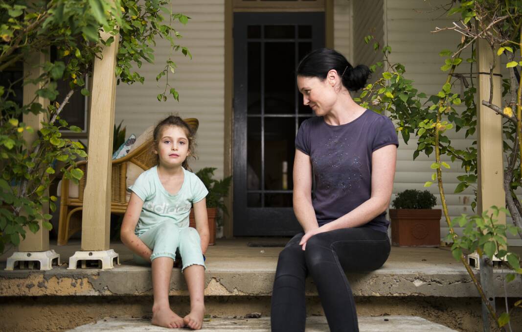Samara Zeitsch and her daughter Evie Clark 7 at their Braidwood home. Evie fell onto a wasp nest in Braidwood and was stung by about 200 wasps before being airlifted to Canberra Hospital. Photo: Dion Georgopoulos
