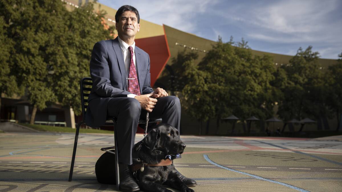 Guide dog handler Scott Grimley has experienced being illegally refused access in the ACT because of his guide dog Dudley. Photo: Sitthixay Ditthavong