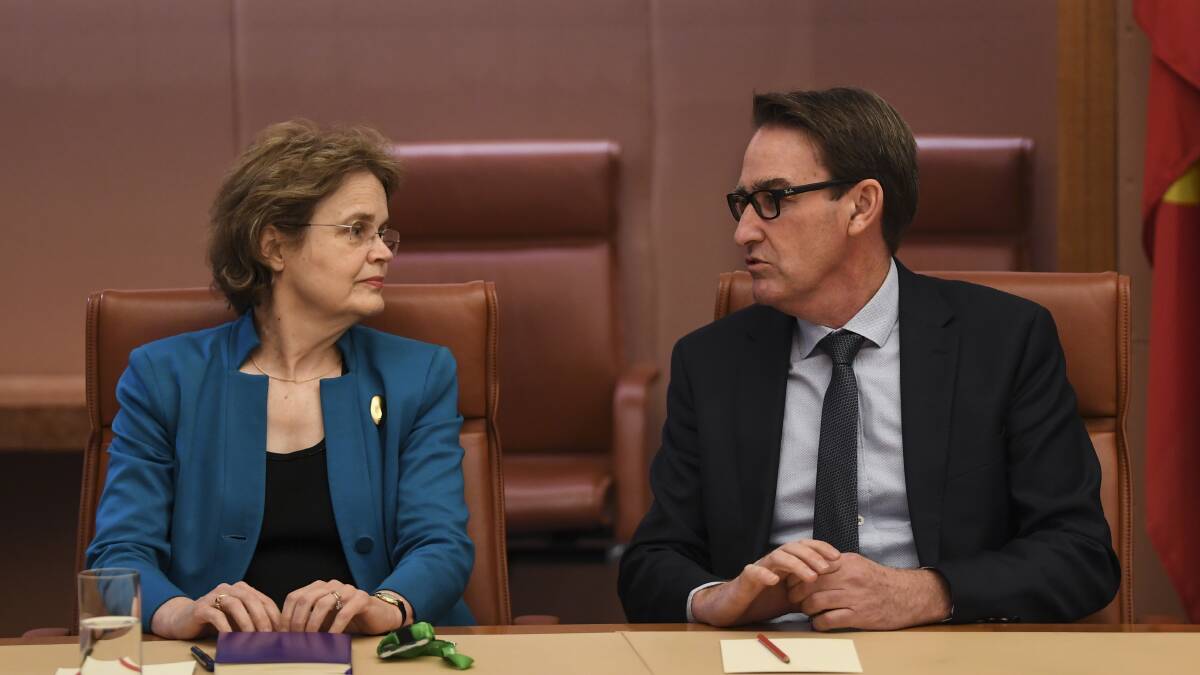 Secretary of the Department of Foreign Affairs and Trade (DFAT) Frances Adamson (left) speaks to the Secretary of the Department of Infrastructure Steven Kennedy. Picture: AAP/Lukas Coch
