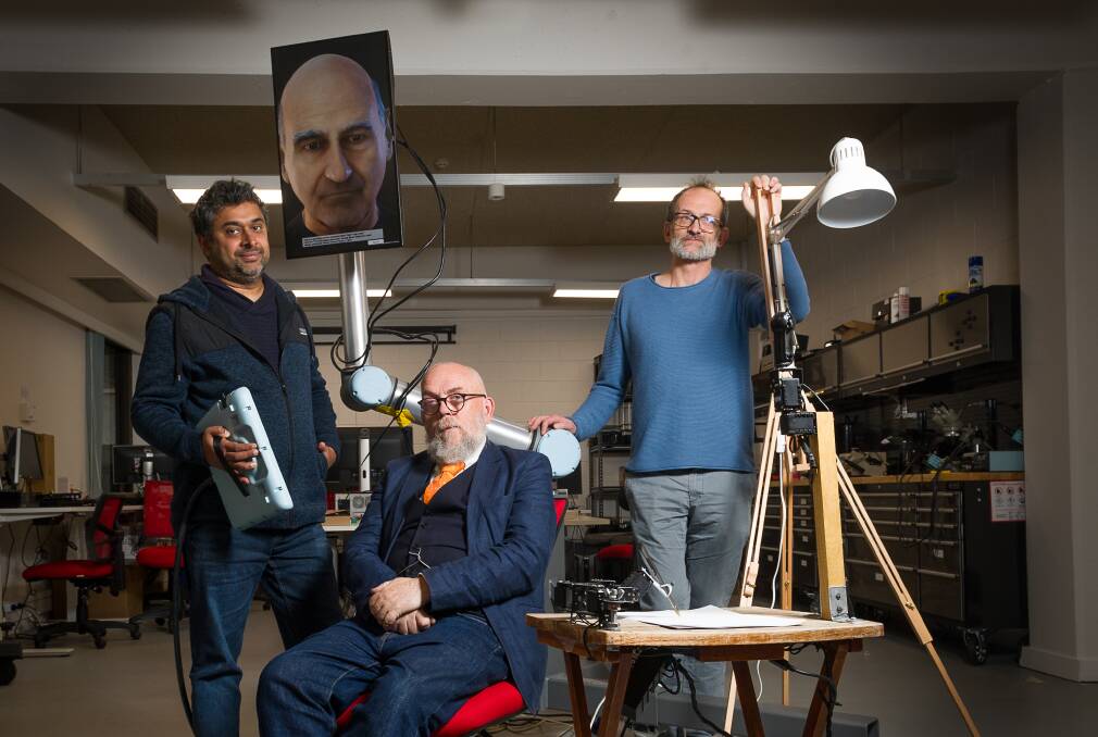 From left: Dr Damith Herath, roboticist, Dr Bruce Baer Arnold, a lawyer examining the legal ramifications of AI (and zombies) and artist Patrick Tresset who designed Paul, a robot that draws people (front right). Picture: Elesa Kurtz