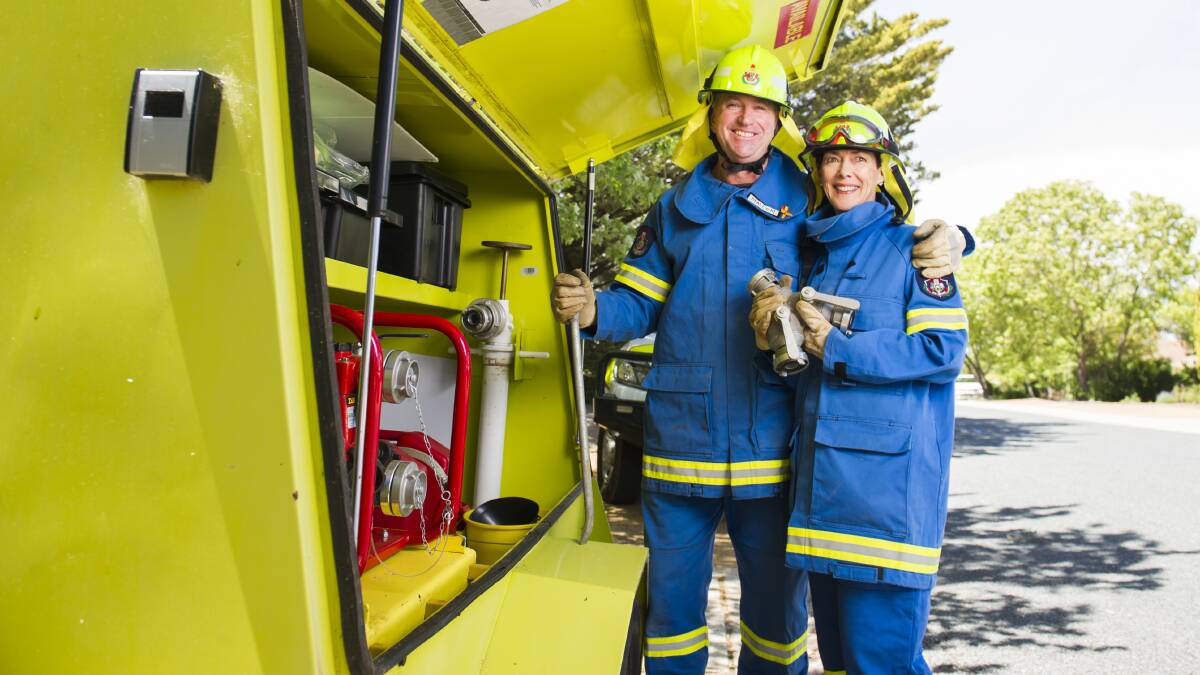 Community fire unit volunteers Malcom Harrington and Gloria Jackson with the firefighting trailer outside their home in Kambah. Picture: Dion Georgopoulos