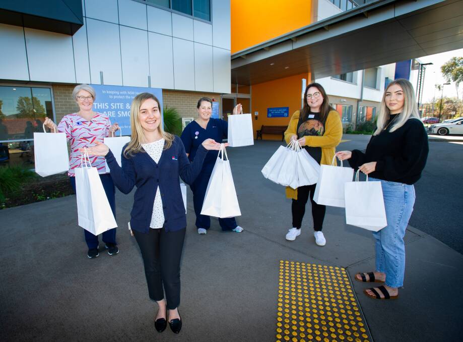 Queanbeyan hospital midwives Jacqui Daniels, maternity unit manager, Amanda Sibley and Jess Mifsud receive donations of DMK skincare products from The Lab Skincare Clinic co-owner Tegan Williams and skincare specialist Hannah Corcoran. Picture: Elesa Kurtz.