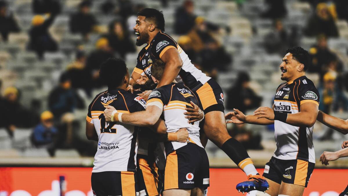 Brumbies V Melbourne Rebels at GIO Stadium, 4th of July 2020. The Brumbies celebrate with Andy Muirhead after he scores a try. Picture: Dion Georgopoulos