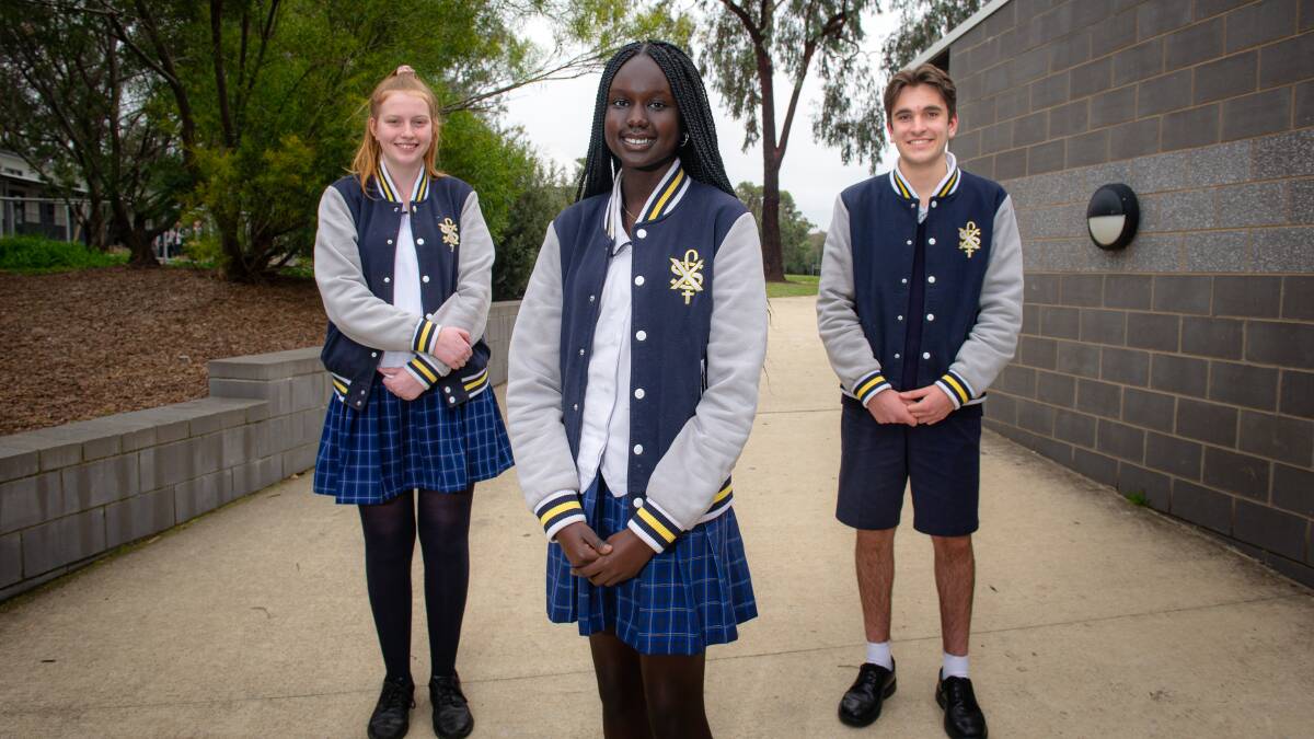 St. Francis Xavier College students Isabella Topp, Abop Akoi and Anthony Gambale were happy to have received an early offer for ANU as part of a special COVID-19 round. Picture: Elesa Kurtz