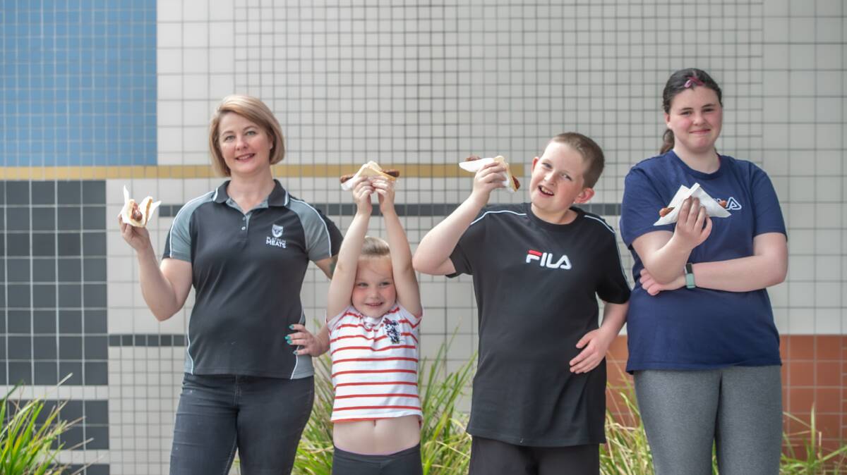 Kristy Alderson of Platinum Meats has donated sausages to the Namadgi School for their election sausage drive, pictured with Ashleigh Ellison, Year 1, Nathan Nowak, Year 6 and Maddie Nowak, Year 8. Picture: Karleen Minney