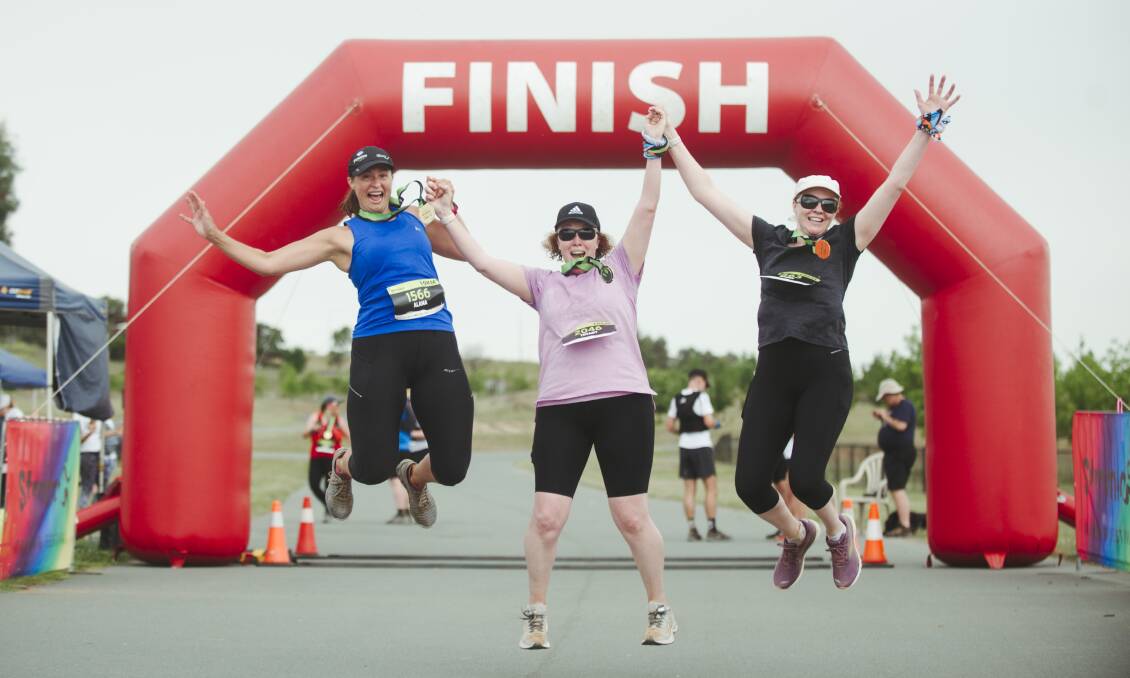 Stromlo Running Festival participants Alana, Tiffany, and Naomi Mahon celebrate finishing the 10km run on Sunday. Picture: Dion Georgopoulos