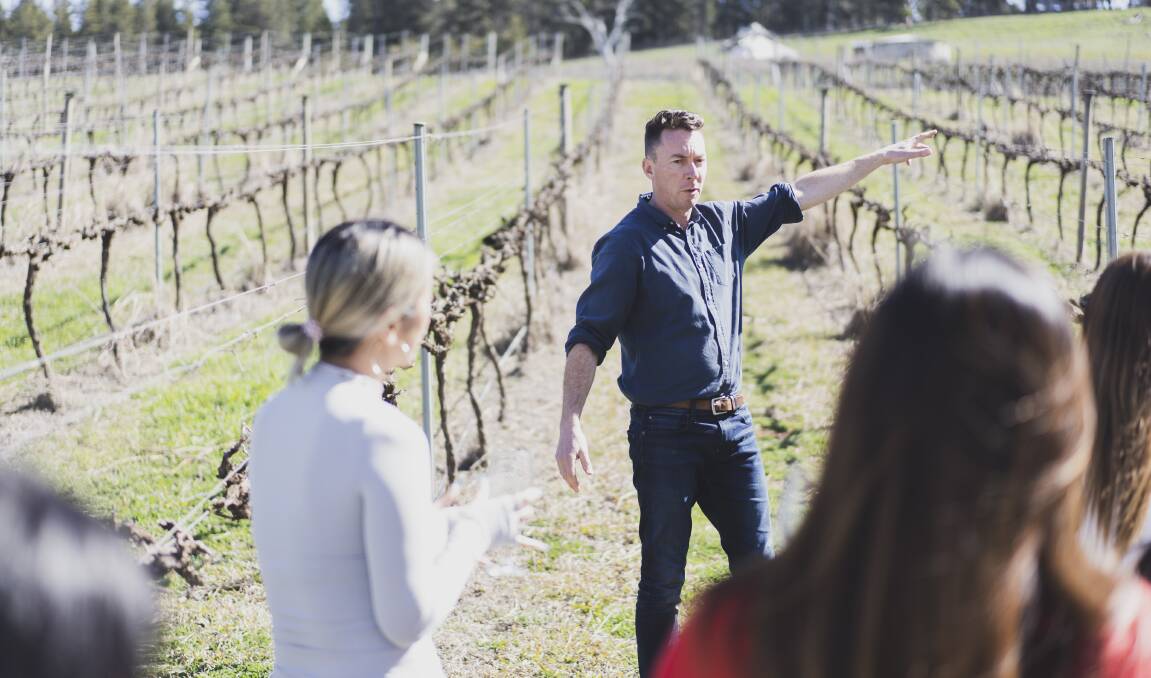 Mt Majura Vineyards sales manager Fergus McGhie explains the self-guided gumboot tours to a group of wine-tasters on Monday. Picture: Dion Georgopoulos
