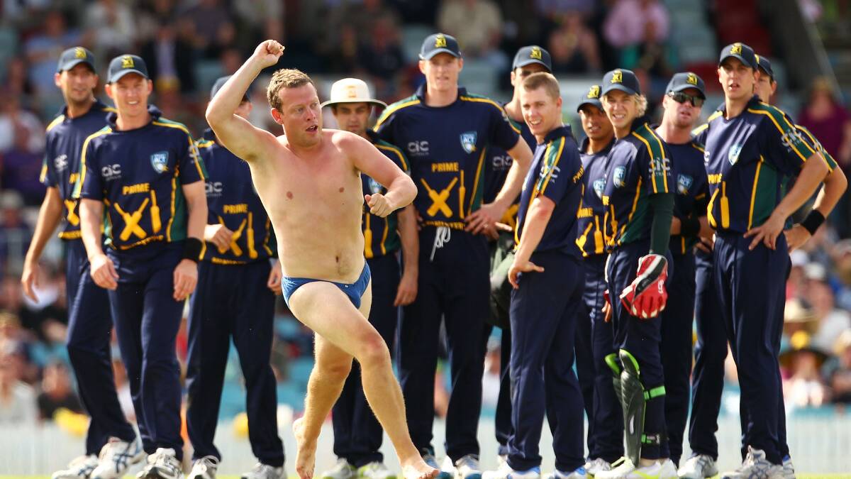 A pitch invader at Manuka Oval. Penalties of up to $8000 will now apply. Picture Getty Images