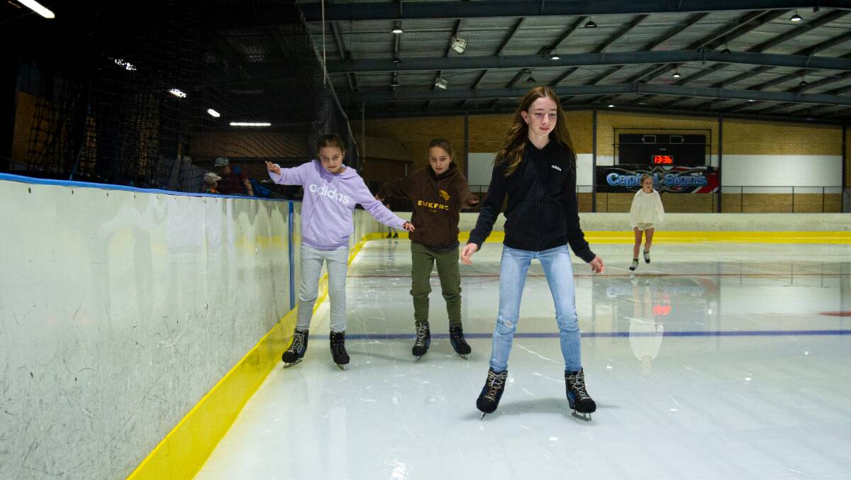 Wagga twins, Paige and Chloe Boyles, 10, with sister Annabelle, 12, keeping it cool at the Phillip ice rink. Picture: Elesa Kurtz