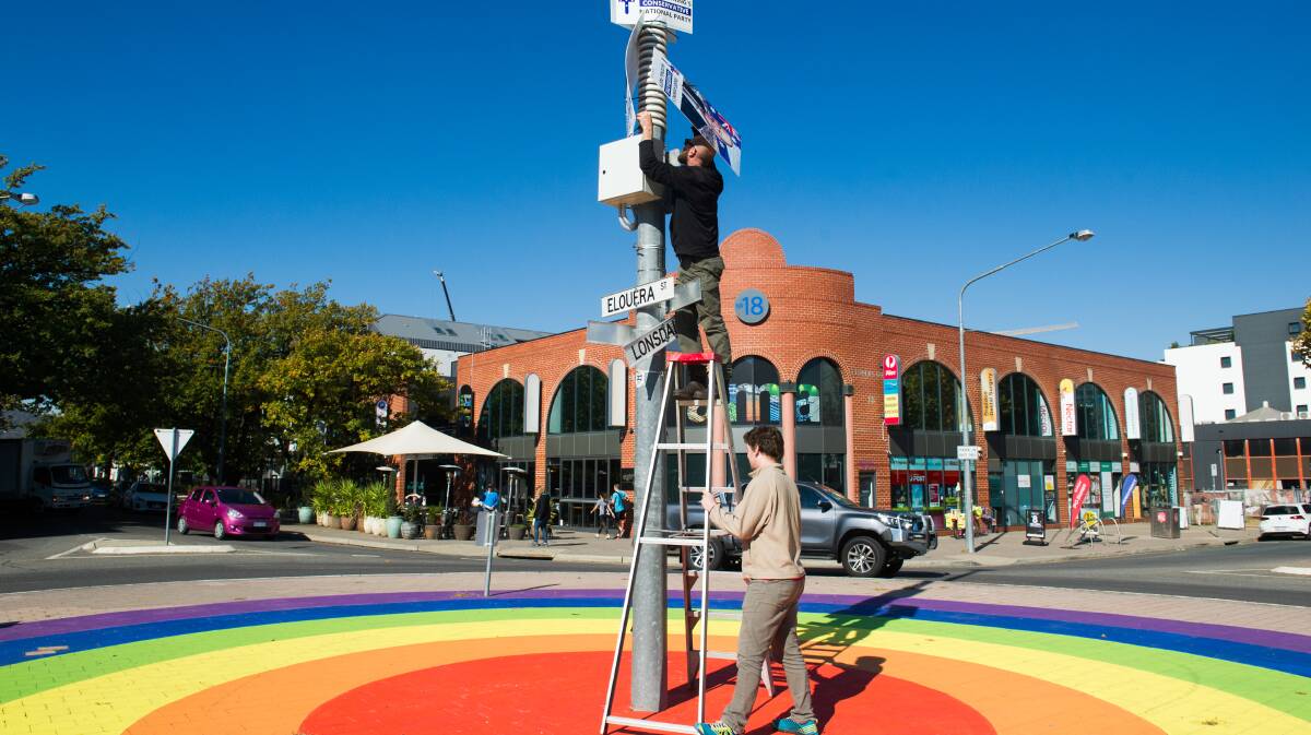 Unnamed local residents take down Fraser Anning core flutes placed in middle of rainbow roundabout in Braddon. Picture by Elesa Kurtz