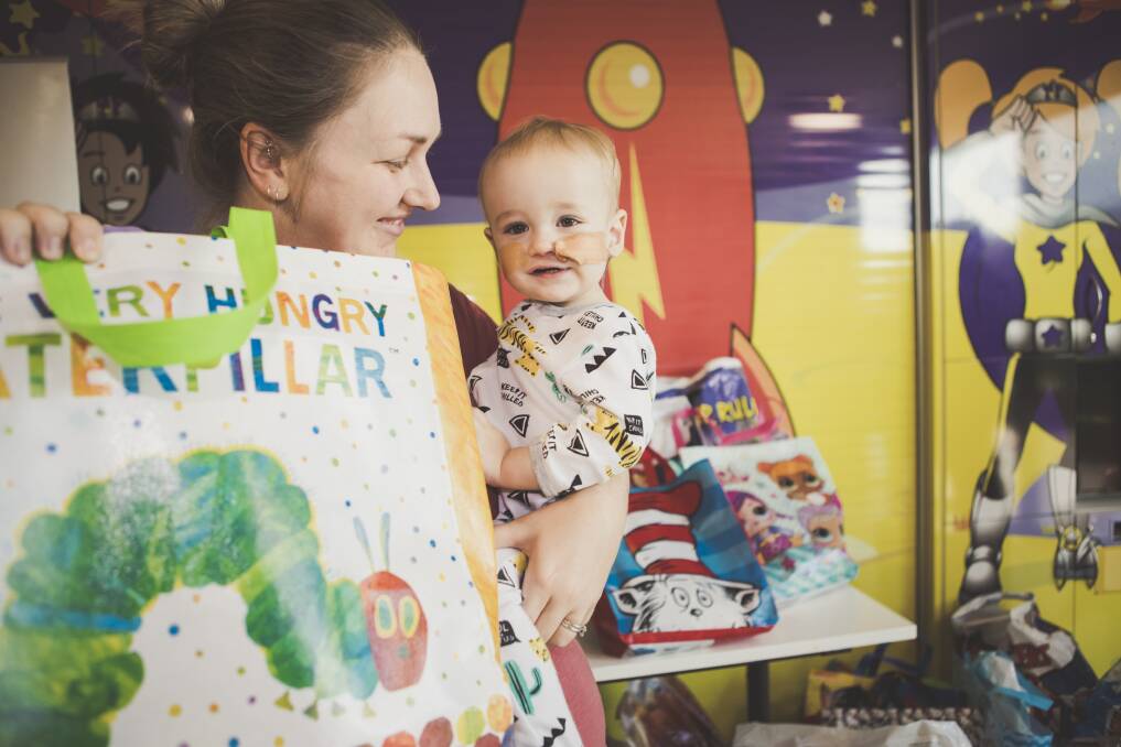 Tamryn Marek with her son Leon, 1, at Canberra Hospital, awash with showbags.
 Photo: Jamila Toderas