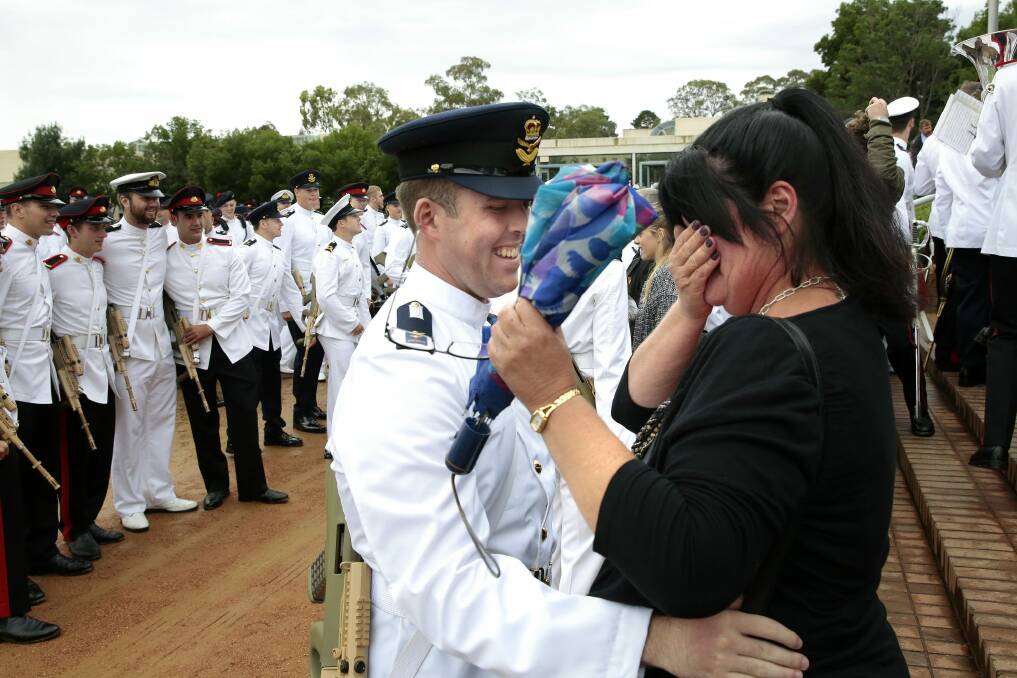 Memorable moment: Graduate Air Force Officer Cadet Joshua McNickle hugs from his mother Vicki Collins. Photo: Jeffrey Chan