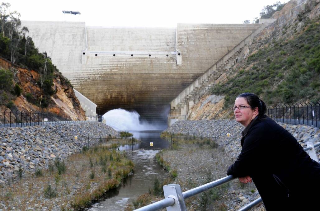 Ellen Schwab, digital education and engagement officer at Icon Water, with the Cotter Dam wall behind her. Photo: Melissa Adams 
