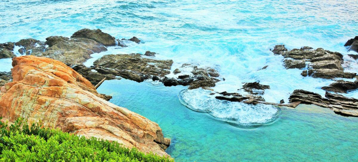 At the bottom of imposing cliffs, Bermagui's Blue Pools is a haven for families on a hot summer's day. Photo: Supplied