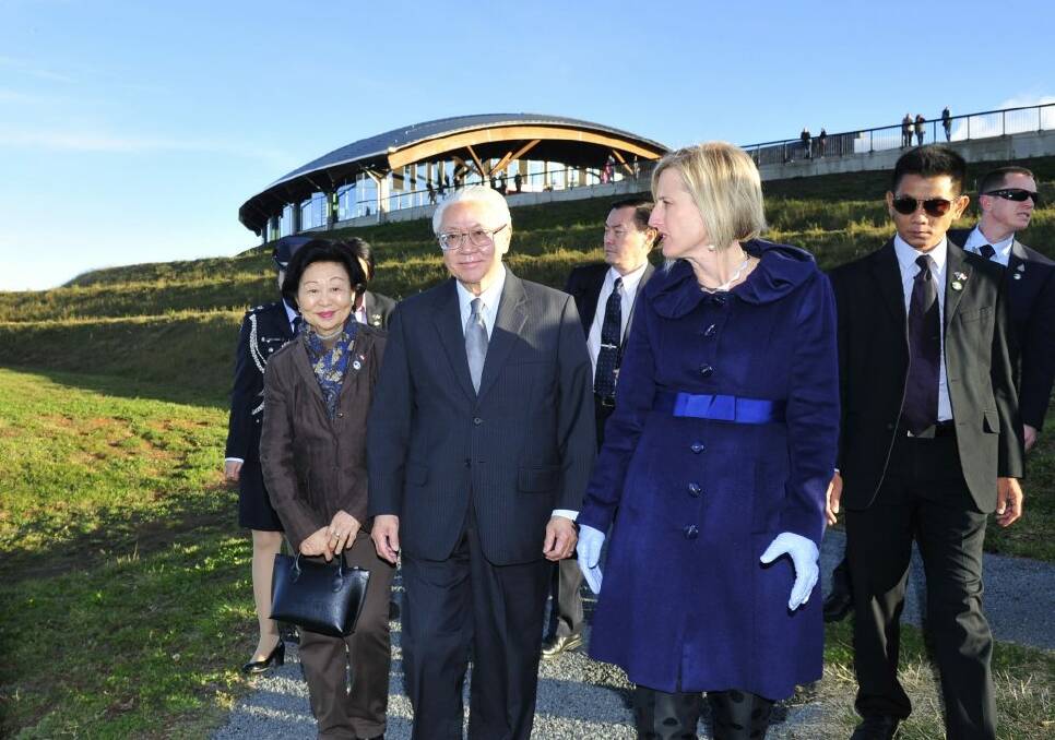The President of the Republic of Singapore, Dr Tony Tan Keng Yam and, left, Mary Tan meet with ACT Chief Minister Katy Gallagher at the National Arboretum, Canberra to plant a pink Silk tree.   Photo: Melissa Adams