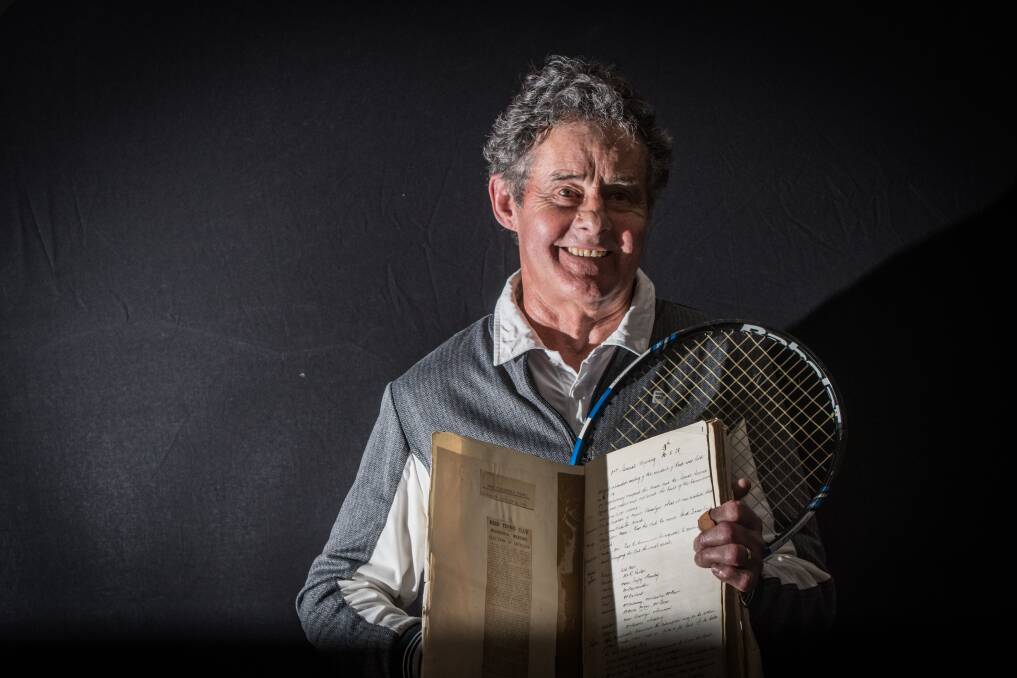 Reid Tennis Club president Terry Walker with the treasured book of minutes that records the very first meeting of the club 90 years ago. Photo: Karleen Minney