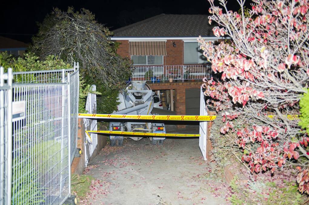 The cement truck was still lodged in the house on Friday night. Photo: Jay Cronan