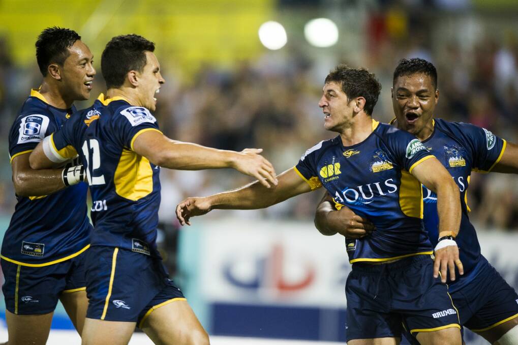 Tomas Cubelli is mobbed after his first try for the Brumbies. Photo: Rohan Thomson