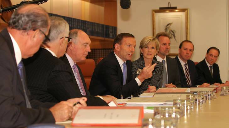 Prime Minister Tony Abbott address colleagues in a cabinet meeting. He has said that repealing the carbon tax is the priority for the government in negotiations with the incoming Senate. Photo: Alex Ellinghausen