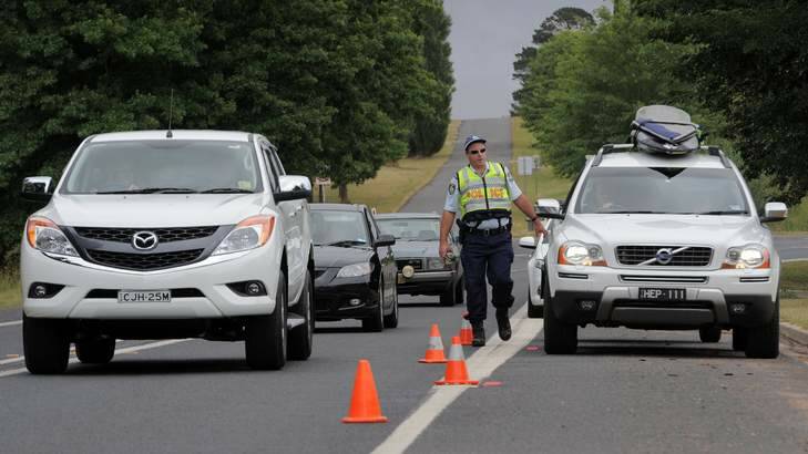 NSW Police conducting random breath tests on motorists entering the township of Braidwood, as the annual exodus to the south coast from Canberra begins. Photo: Graham Tidy 