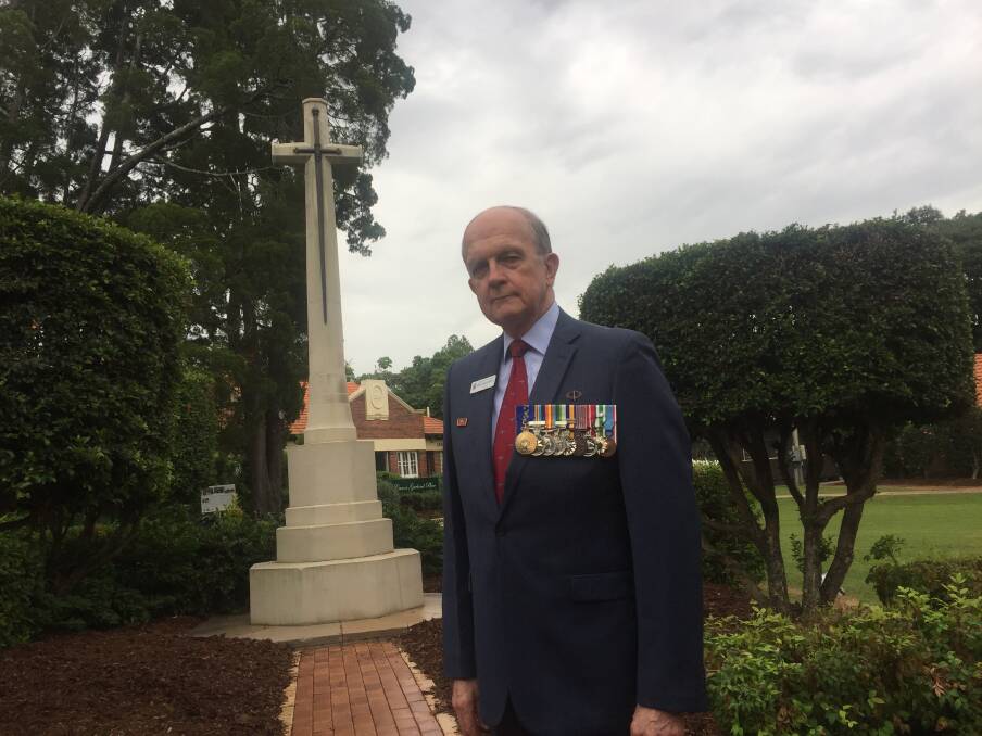 Toowong RSL branch president Kerry Gallagher AM  at the restored Cross of Sacrifice at Toowong Cemetery. Photo: Tony Moore