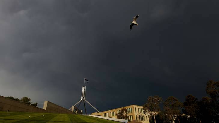 A storm brews over Parliament House in Canberra. Photo: Alex Ellinghausen