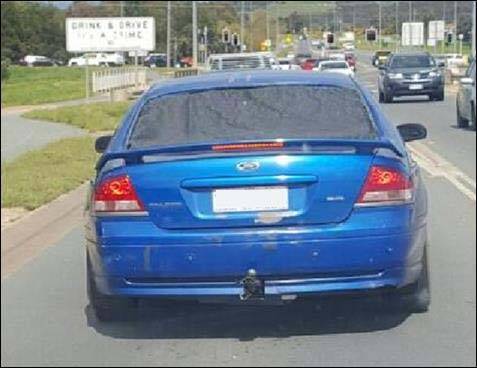 The blue Ford Falcon, had number plates that did not match the vehicle type and a missing rear windscreen. Photo: ACT Policing