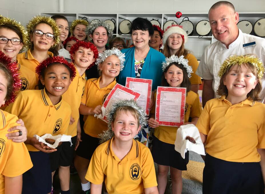 Executive Chef at Parliament House David Learmonth (right) with Weetangera Primary School choir leader Jan Lloyd-Jones (centre), APH Pastry Chef Amanda Polsen (third from left) with choir members.  Photo: Supplied