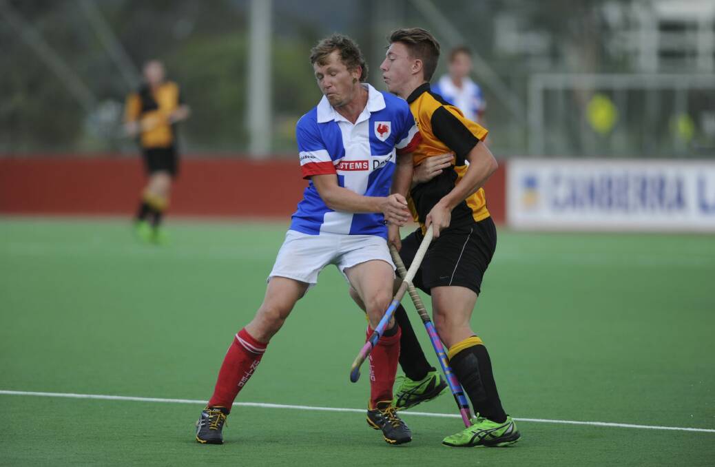 Old Canberran' Lewis McLennan clashes with United's Stuart Shepherd.
 Photo: Graham Tidy 