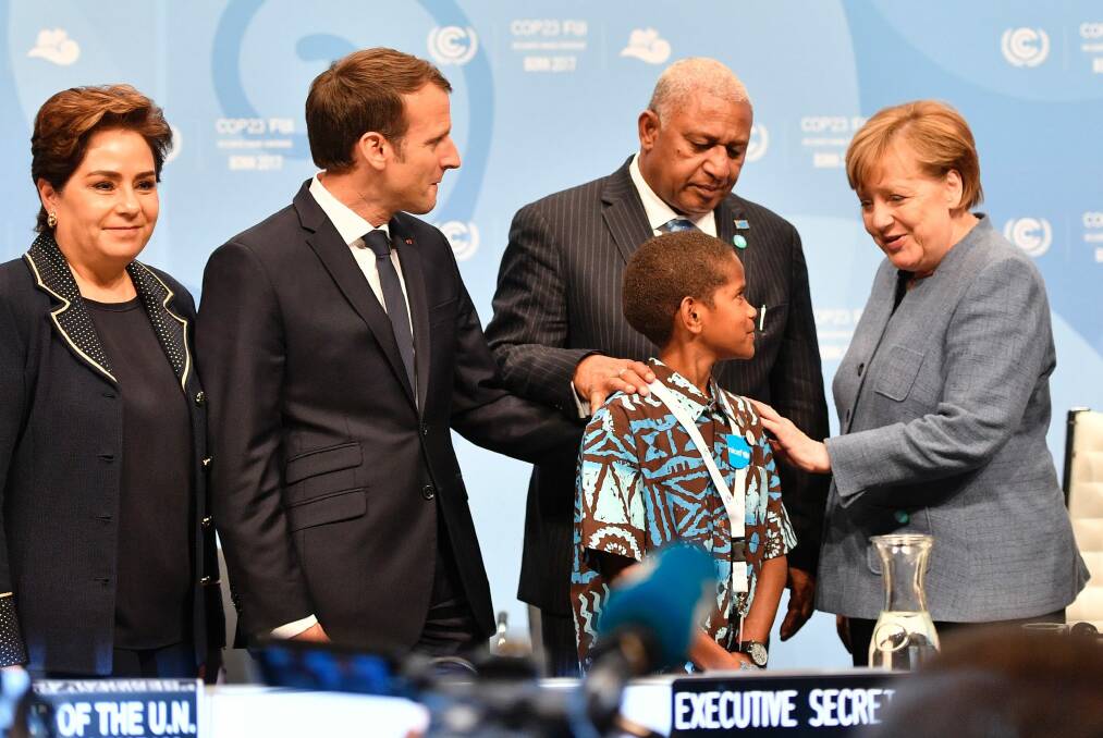 German Chancellor Angela Merkel and world leaders, with Fijian child Timoci Naulusala at the United Nations climate change talks in Bonn Photo: AP