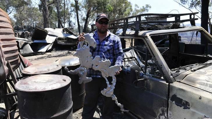 UNRECOGNISABLE: Son Mark Webster with melted metal from his property. Photo: Jay Cronan