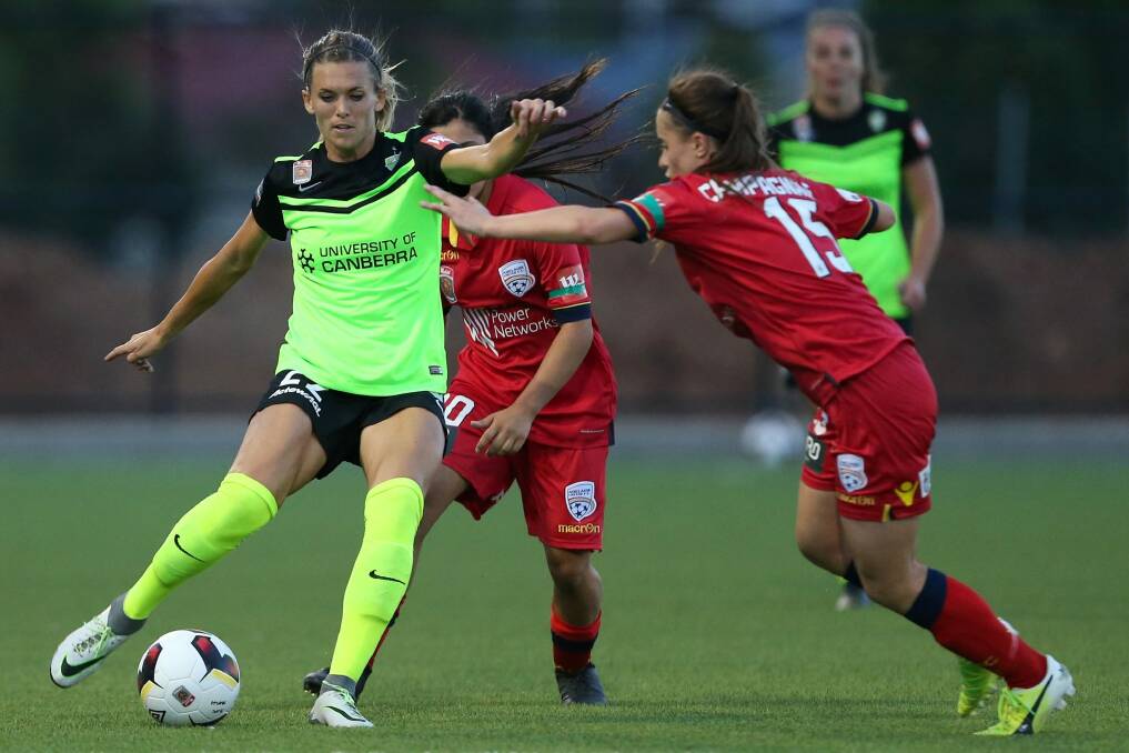 Stephanie Ochs of Canberra is tackled by Georgia Campagnale of Adelaide. Photo: James Elsby