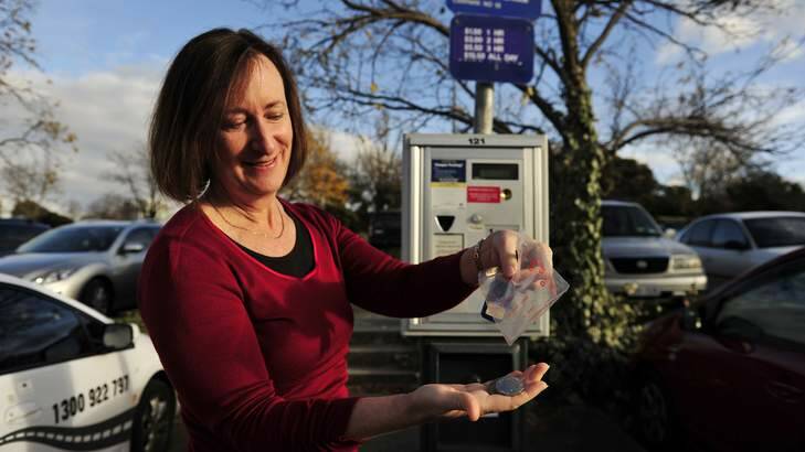 Janine Ryan pre-packages coins for weeks parking meter at the Civic Centre car park. Photo: Jay Cronan