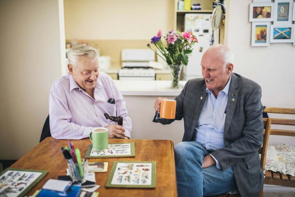 Jim James at home with Palliative Care ACT volunteer Peter Sutton. Photo: Rohan Thomson