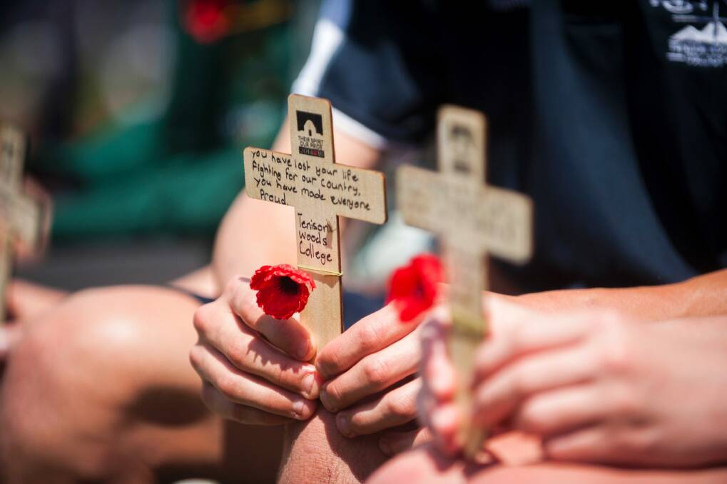 Students wrote messages for fallen servicemen and women before laying them on the Stone of Remembrance. Photo: Dion Georgopoulos