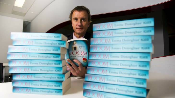 Professor Nick Klomp with copies of the University of Canberra's book of the year, <em>Room</em> by Emma Donoghue. Photo: Rohan Thomson