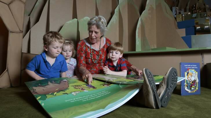 MAGIC: Co-author Suzie Campbell reads to Henry Puleston, 4, left, Maisie Puleston, 2, and Tom Glasson, 4, at the Gold and the Incas exhibition children's room at the National Gallery. Photo: Jeffrey Chan