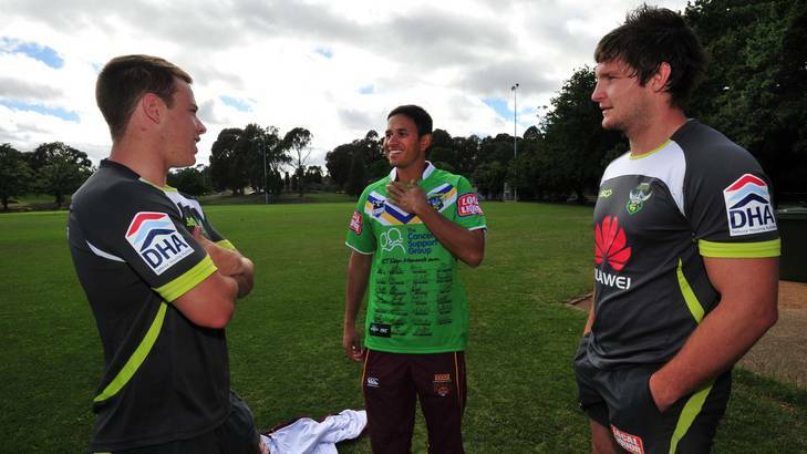 Usman Khawaja chats to Raiders players Sam Williams, left, and Jarrod Croker after receiving a signed Canberra jumper. Photo: Karleen Minney