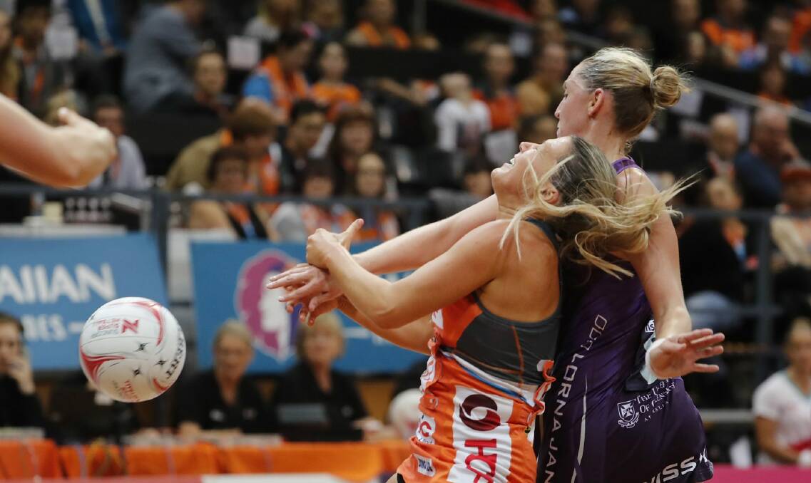 Collision: Giants wing attack Sarah Wall loses the ball. Photo: Getty Images